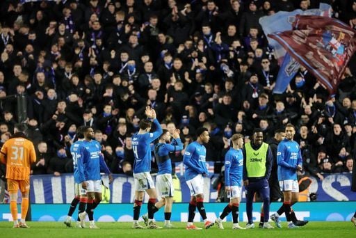 Rangers players applaud the fans after the win.