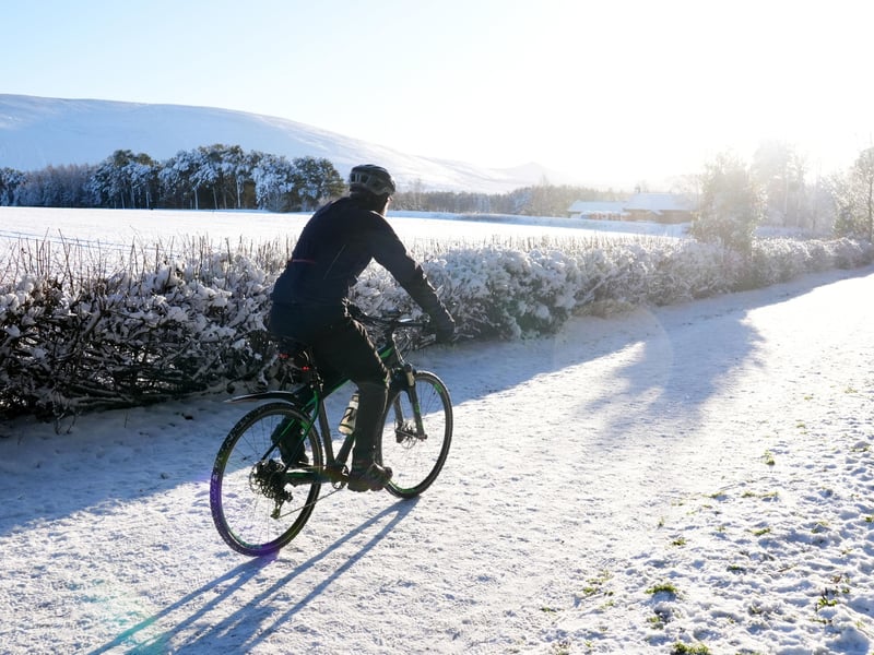 A person takes a wintery New Year cycle through the Pentland Hills.