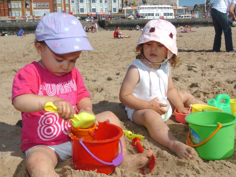 Hot weather on Blackpool Beach. L-R Tara Williams (20 months) with Monica Santaolalla-Ristic (2) making sand castles
