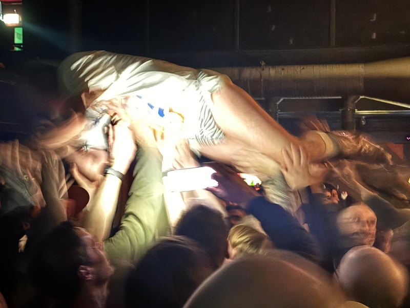 Yow being carried over the crowd.