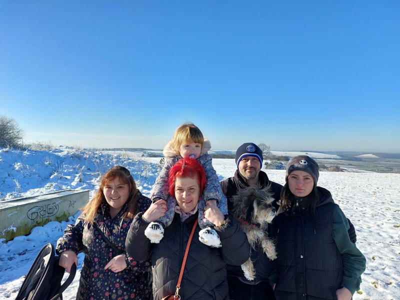 Jasmine Orton, Tanya Penwarden with Lilli-Ann Beaver on her shoulders, Woody Gray with Bella the dog, and Carla Orton, from Havant, enjoy a a snowy winter walk on Butser Hill.