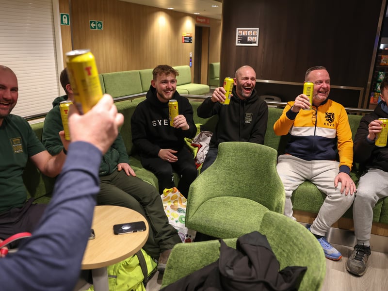 Passengers enjoy a refreshment onboard the Glen Sannox for its first official passenger sailing in Troon