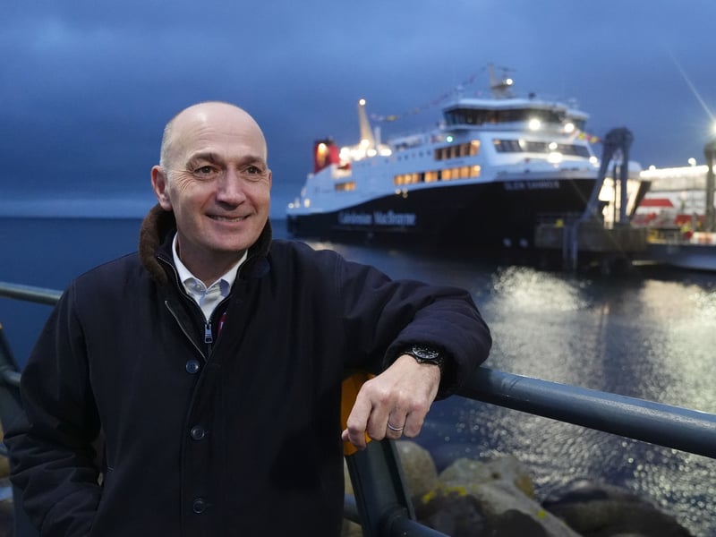 Caledonian MacBrayne chief executive Duncan Mackison beside The Glen Sannox ferry after it arrived at Brodick on Isle of Arran on its first official day in service