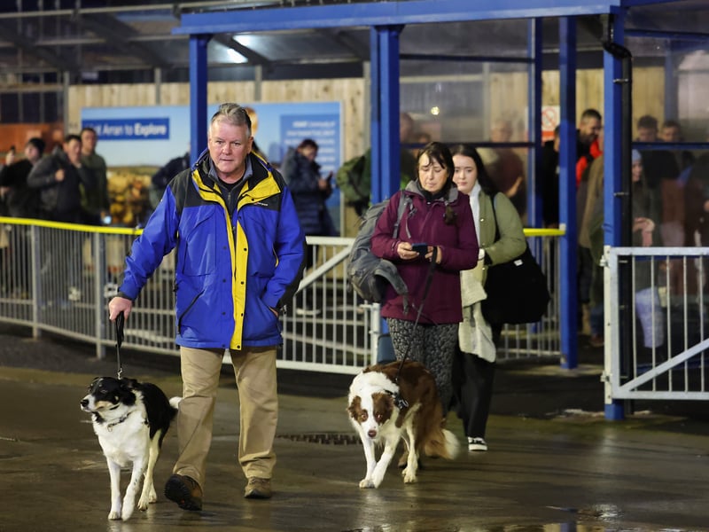 Passengers with their dogs board the Glen Sannox for its first official passenger sailing in Troon on Monday