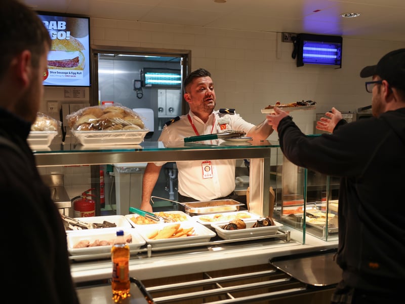Passengers purchase a breakfast onboard the Glen Sannox for its first official passenger sailing in Troon on Monday