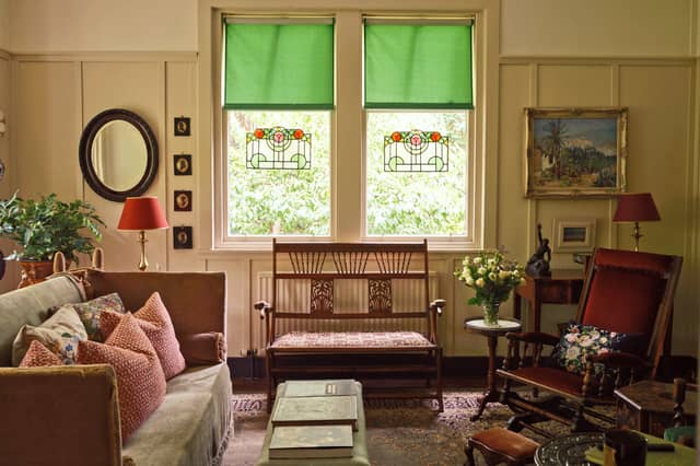 The living room with restored stained glass windows and period furniture