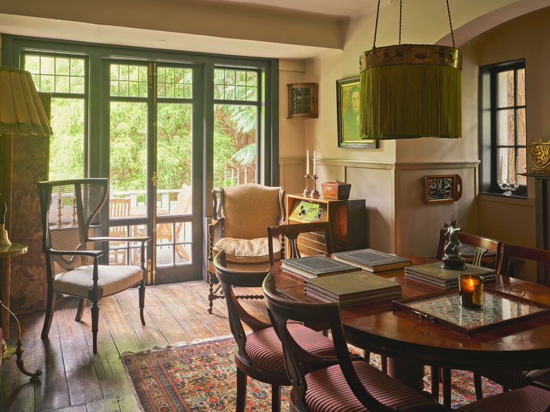 The oak-floored dining room, which extends out to the wooden terrace overlooking the garden