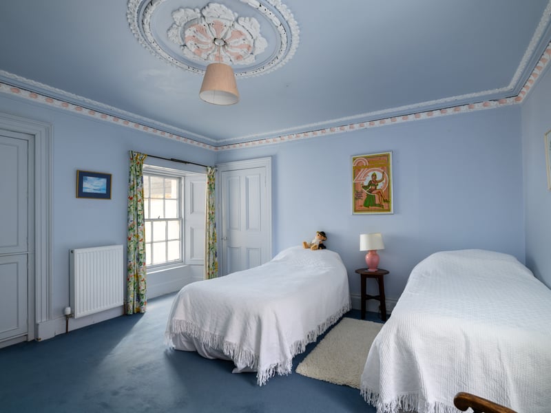 One of the four bedrooms with decorative ceiling. The house would be suited as a family home.