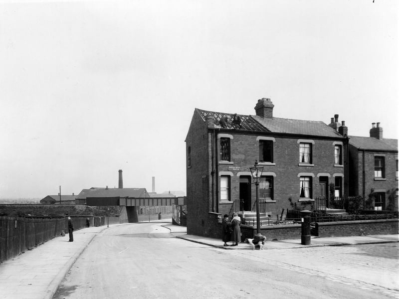Nursery Mount Road, off Belle Isle Road in May 1938. On the left is an embankment carrying the Hunslet branch line of LNER, with a metal bridge over the road. The factory beyond is the Cooperative Wholesale Society brush factory. Two workmen are removing slates from the roof of number 1.