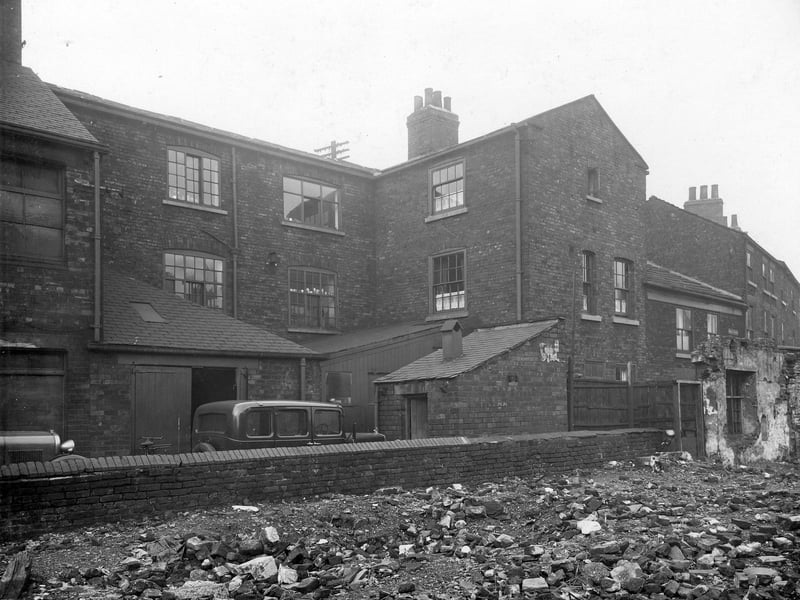 Rubble in foreground is an area where a house has been demolished. Beyond the wall are the buildings of E. Rawling Ltd., printers and stationers with a yard in front. These buildings fronted on to Salem Place. Ward's Court is to the right of the photo from October 1935.