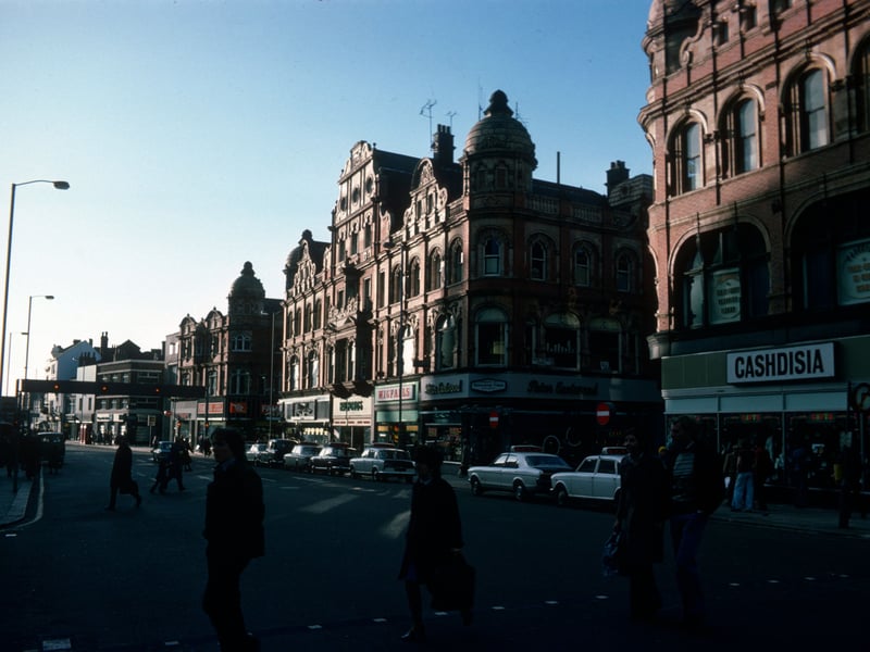 Looking south along Vicar Lane showing shops on the west side in  January 1976. On the right is Cashdisia, ladies, mens and childrens wear, then after the junction with Queen Victoria Street are Peter Eastwood menswear, Wigfalls TV and electrical, Halfords cycle and car accessories and John Collier tailor. Next is the junction with King Edward Street then the Famous Army Stores.