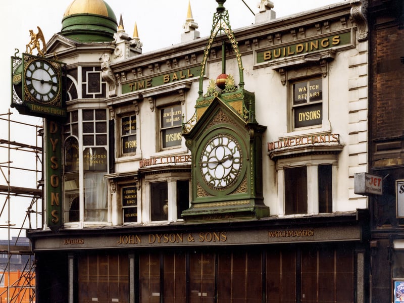 The grade II listed Time Ball Buildings at Numbers 24, 25 and 26 Briggate. They date from the early nineteenth century but much of the elaborate facade was added from 1872 when John Dyson, watchmaker, became established here. Pictured in November 1979.