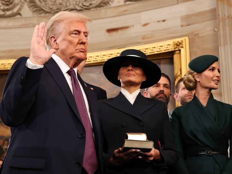 Donald Trump takes the oath of office as his wife Melania and his children look on.