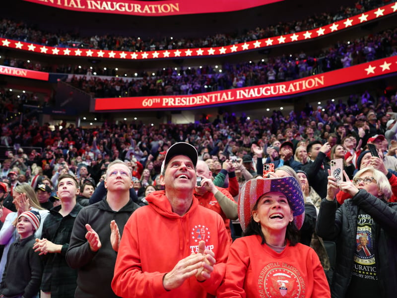 People watch the inauguration of President Donald Trump live from the nearby Capital One Arena in Washington. Trump later addressed the crowd.