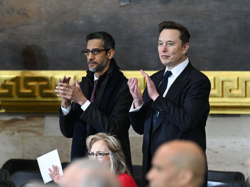 Google CEO Sundar Pichai and Tesla and SpaceX CEO Elon Musk applaud before the start of the inauguration ceremony.