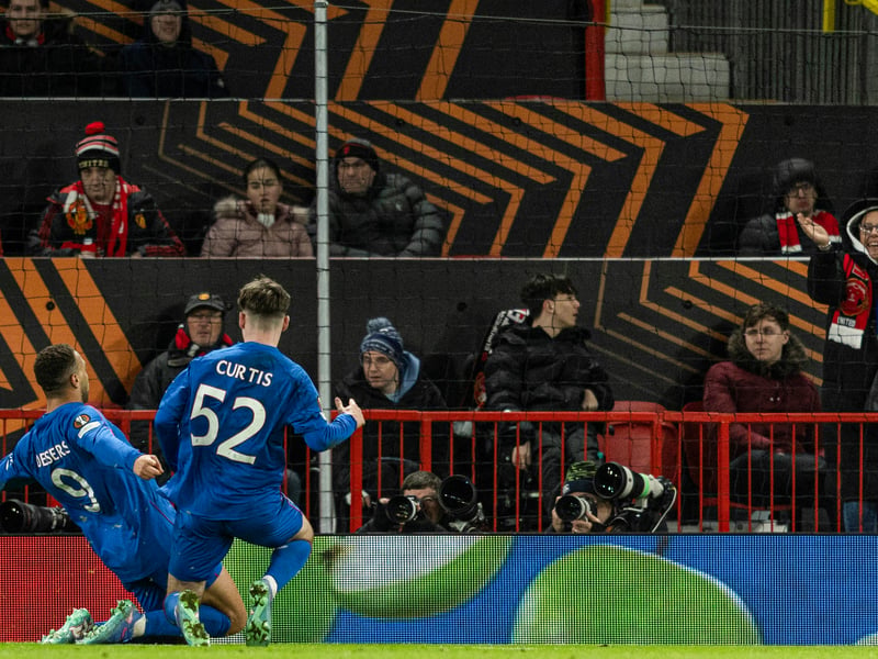 A loan Rangers fan celebrates Cyriel Dessers' late equaliser at Old Trafford.