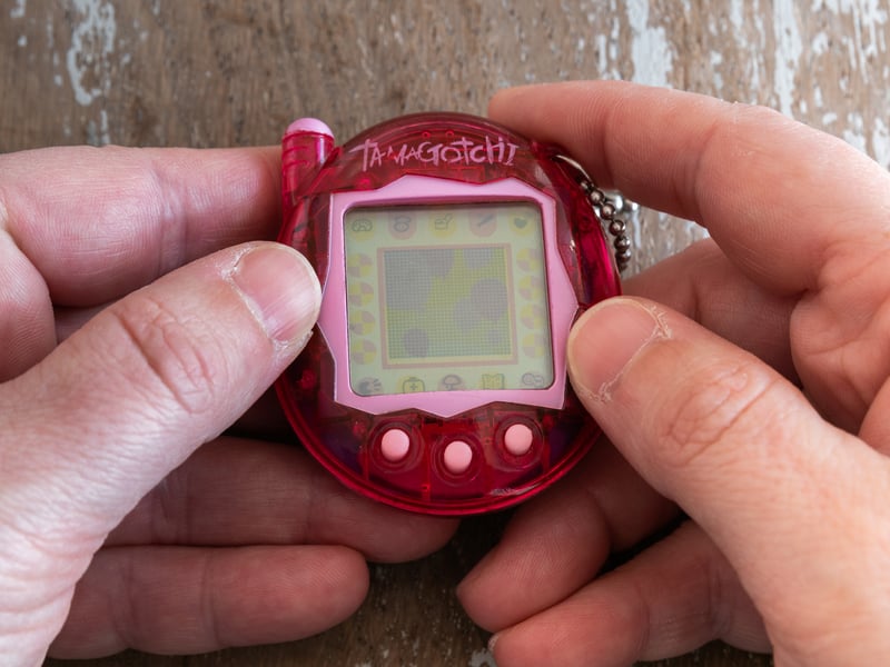 Tamagotchi are tiny virtual pets in a distinctively egg-shaped case, which allows you to carry them around with you. You would raise your pet from egg to adult, taking care of their needs to keep them happy and healthy.
Originally from Japan, Tamagotchi became a sensation across the world in the late 90s and early 2000s. However, they ended up being banned in quite a number of schools. This was in large part because of how distracting they were, with pets frequently becoming hungry, unhappy, or even sick if you didn’t clean up their droppings. No kid wanted their Tamagotchi to die, and that - combined with their constant beeps when they needed attention - didn’t exactly make them a good fit for the classroom.