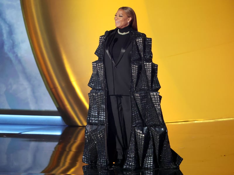 Queen Latifah is another person who ruined a lovely black suit by attaching something else to it. I like the added glitz but the huge overcoat is a bit much. (Photo by Amy Sussman/Getty Images)