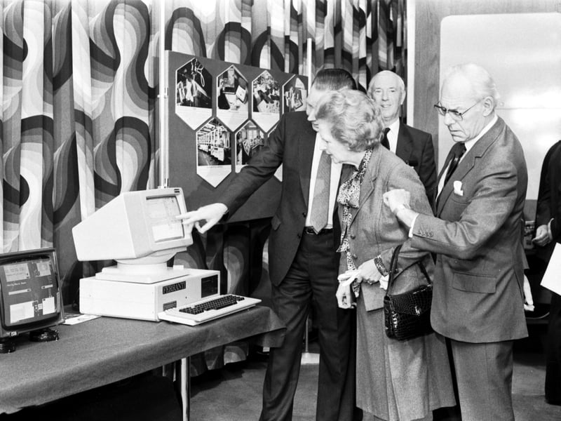 Prime Minister Margaret Thatcher (now Baroness Thatcher) is interested in the latest technology , but husband Denis Thatcher looks at his watch on a visit to the Ferranti factory in South Gyle Edinburgh, September 1986