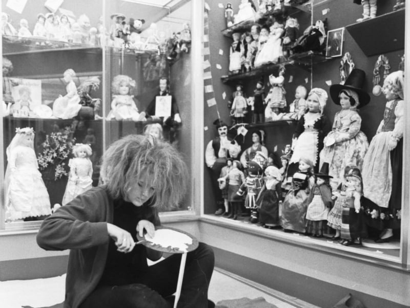 A museum employee working on an antique doll at the Museum of Childhood in September 1986.