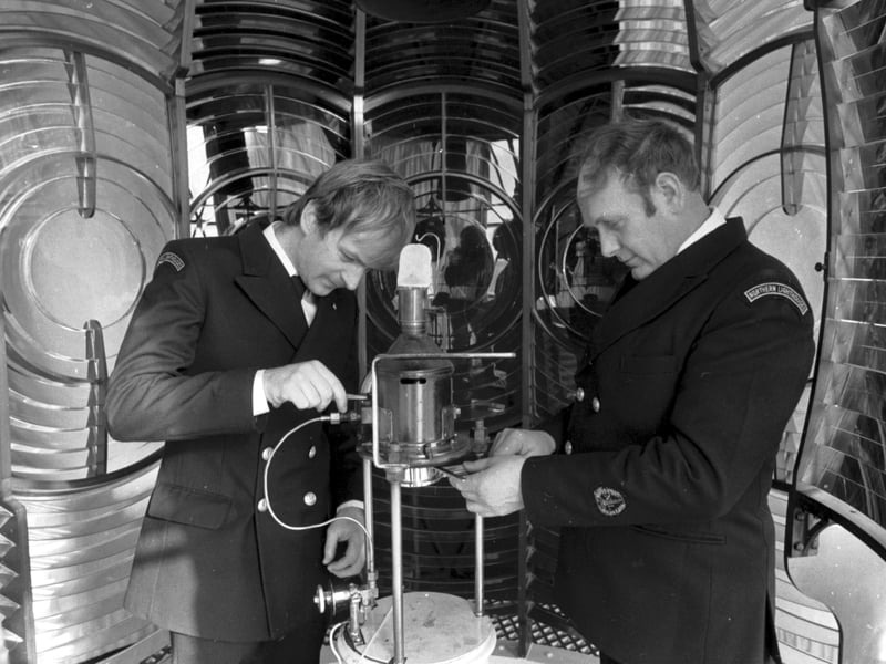 Two men from the Northern Lighthouse Board in the lamp room of the Bass Rock lighthouse in April 1986.