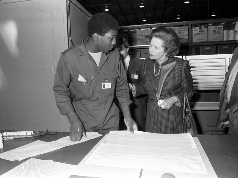 Prime Minister Margaret Thatcher arrives at the WL Gore & Associates factory (manufacturers of Gore-Tex) in Livingston in September 1984. Mrs Thatcher is seen speaking to factory worker Akin Akiniawi.