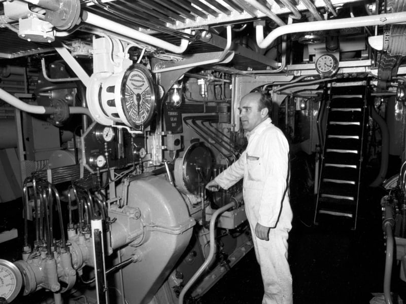 A crew member working in the engine room of the Pharos lighthouse vessel in the Firth of Forth, October 1984.