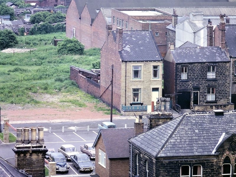A view taken by telephoto lens from the tower of Morley Town Hall looking towards Middleton with Leeds on the horizon. In the foreground is part of the Mercantile Club, the car park behind it and some houses in Marshall Street. Behind these are the buildings of a small factory on Ackroyd Street.