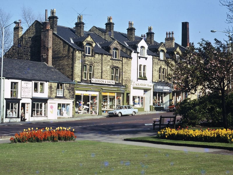 Queen Street entrance to the Hopkins Gardens in May 1973. It was taken looking out of the park on to the rows of shops opposite which include Lewis Hughes (wine and spirit merchant), a nightwear shop, Alderson and Dacre (home furnishings), Jack Stocks (decorator), Brian Senior (menswear) and Chiquita (women's dresses).