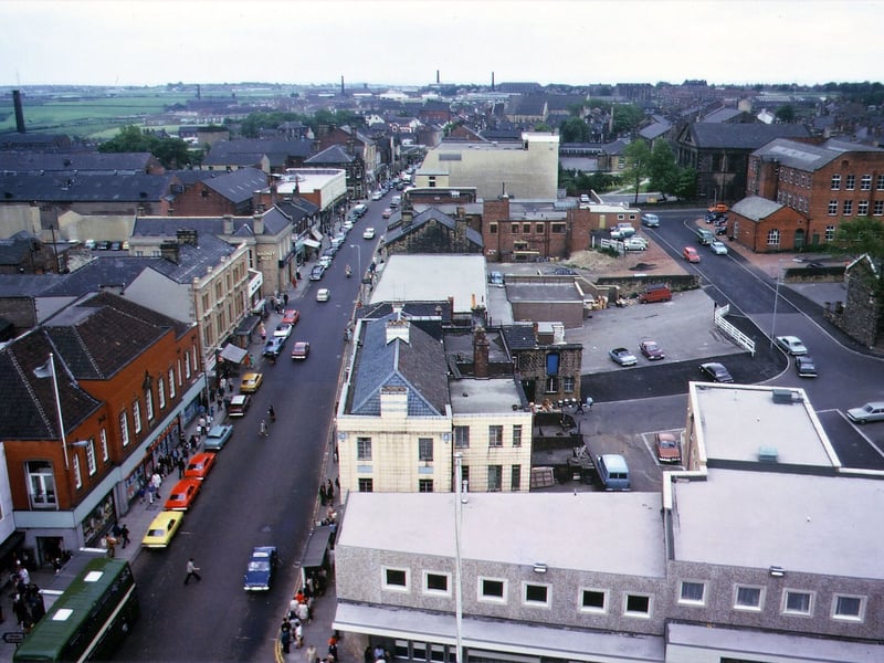 A wide angle view taken from Morley Town Hall Tower looking south along Queen Street with Windsor Court in the foreground. Taken before Queen Street was pedestrianised, Beryl Burton Gardens were built, Sheards was extended and Peel Street Mills was demolished.