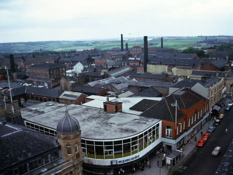 A view south-east over the site of the former Manor House from the tower of Morley Town Hall. The photograph shows Queen Street going across the bottom right hand corner. The foreground has the 1899 Co-op building with turret at the left, the 1957 Co-op Supercentre in the middle and the 1937 Co-op Emporium fronting Queen Street. Pictured in June 1973.