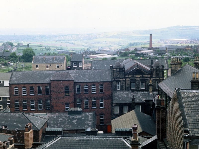 Looking over rooftops of buildings between Queen Street and Commercial Street, probably taken from the Town Hall tower. The red brick building prominent on the left was originally built as a grocery warehouse for the Morley Co-operative Society; it later became a jute factory, which was probably its function at the time of the image.