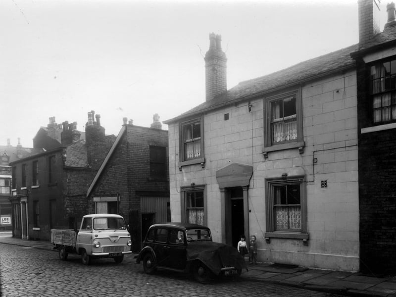 Barrack Street is on the left, number 6/8 can partly be seen. This was a Chinese Laundry. On the opposite corner is 9 Barrack Street, this had been a furniture dealers. Next right is 1 Wilmington Terrace, then a yard which led through to the rear of Willoughby's drapers which faced onto Meanwood Road. The double fronted house to the right is 3 Wilmington Terrace, two children are outside. This had at one time been a public house named the Craven Heifer. 
