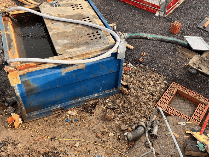 The filtration tank is pumping water out of the ground and back into the drain, so the heavy equipment doesn’t sink.