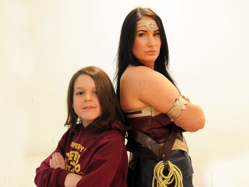 Lydon Figgett, eight, strikes a pose with Wonder Woman.