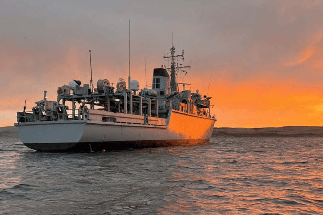 HMS Cattistock at anchor while conducting diving operations. The Royal Navy minehunter is due to replace HMS Middleton in Bahrain, Middle East.