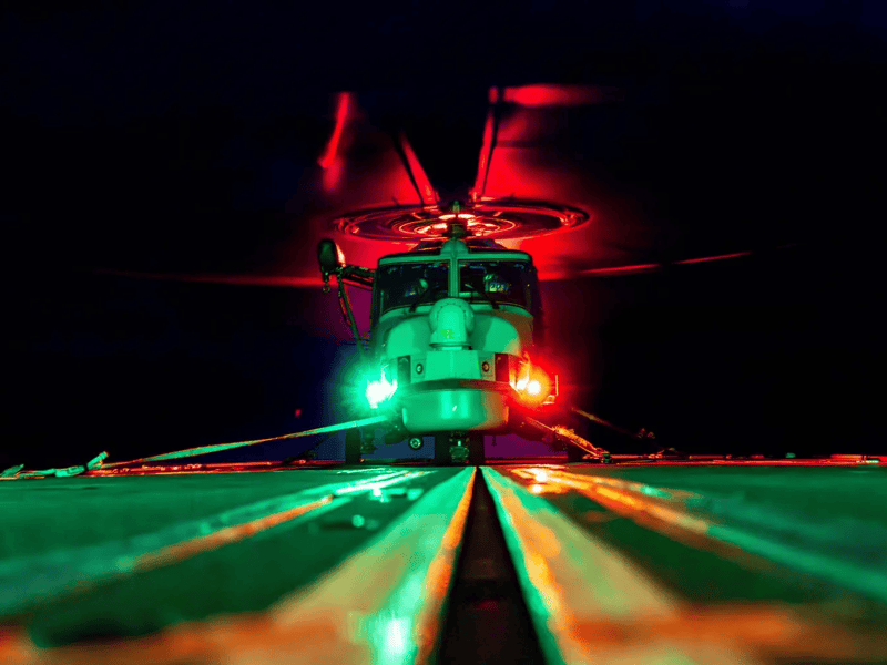 A Wildcat helicopter on the deck of HMS Iron Duke during a night flying exercise.