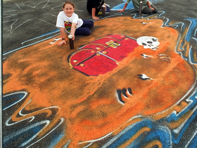 Pupils Holly Hartley and David Battle put the finishing touches to this playground design watched by head teacher Kathy Fiddes as part of the'Anneka Challenge' at Kippax North Junior and Infant School in September 1995.