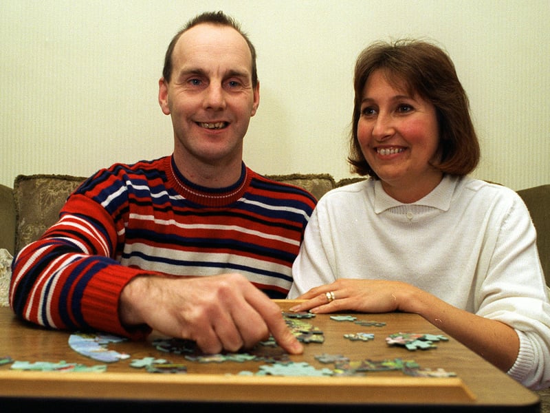 Family placement carer Vivien Nichols is pictured in November 1995 doing a jigsaw with Derek Thorp at her home in Kippax.
