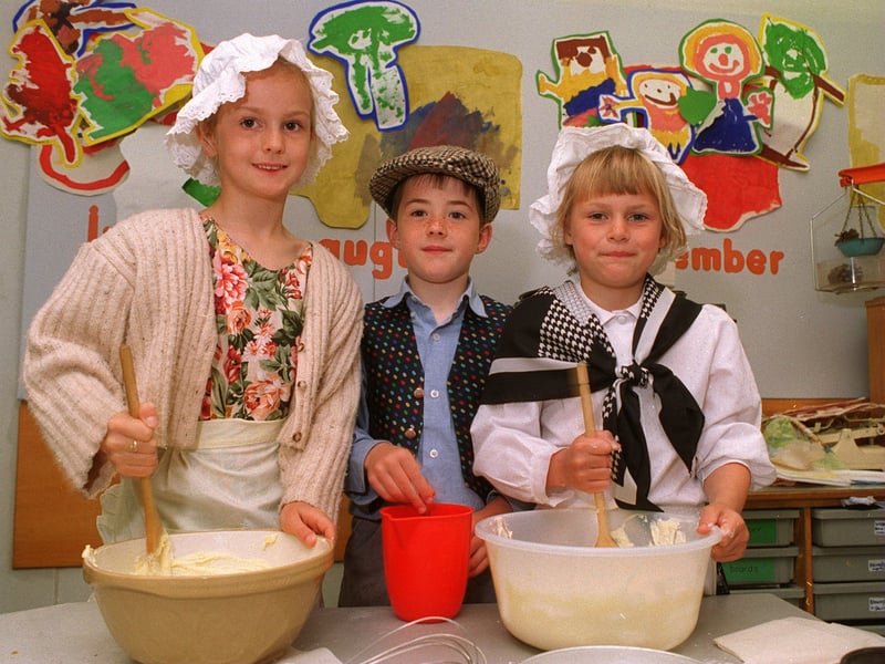 Kippax North Primary School hosted a Victorian Day in July 1996. Pictured, from left, baking cakes are Katie Hewitt, David Carthy and Victoria Watt.