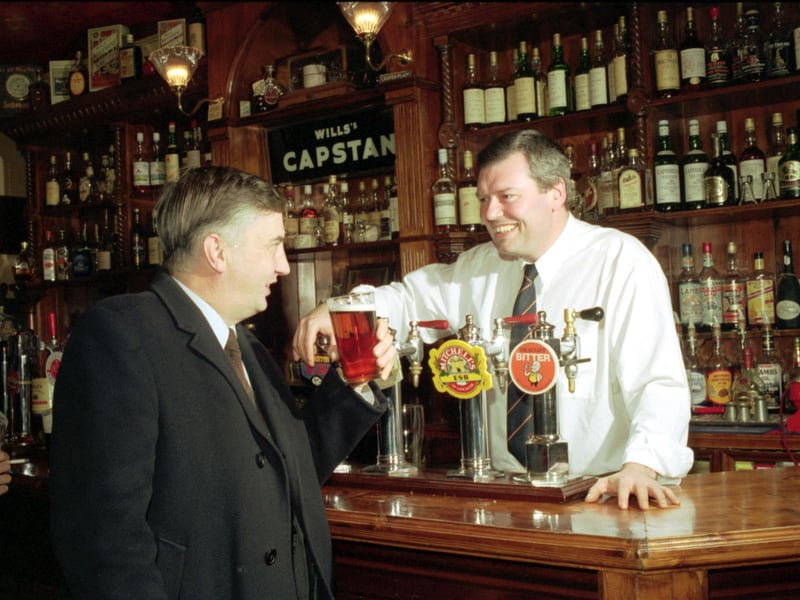 A customer is served with a pint of real ale by Ian Whyte in Edinburgh's Bow Bar (Evening News Pub of the Year), December 1990.