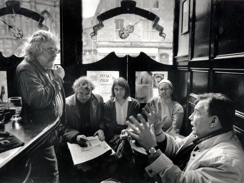The poets' "kitchen cabinet" enjoys a friendly discussion in Sandy Bell's pub in Forrest Road, Edinburgh in November 1994. 