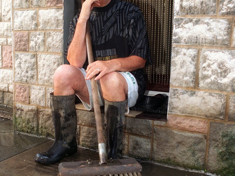 Tom Jackson of Station Road enjoys a rest after clearing  the flood water caused by a storm in September 1997. He still had around 3ft 6'' of flood water under his house.