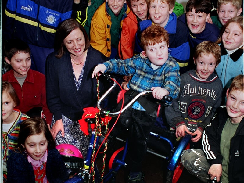 Four-year-old Charles Payne, four, with sporting youngsters after receiving his new bike at Kippax Welfare and Social Club. Also on the photo from December 1998  is his mum Barbara.