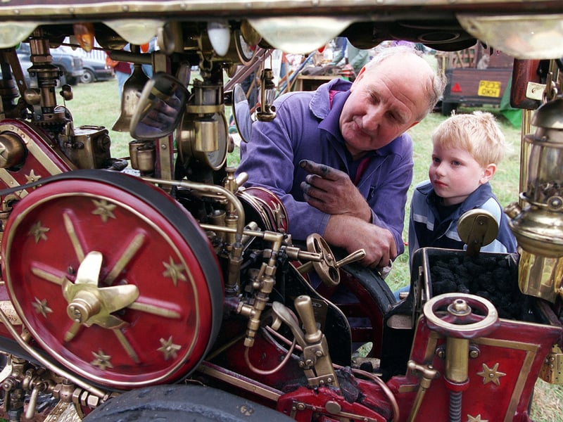 Arthur Boothroyd, from Kippax, shows Benjamin Winn the workings of his 1/4 scale Showmans Steam Engine he built which took him three years to complete. He is pictured at Wetherby Show in June 1999.