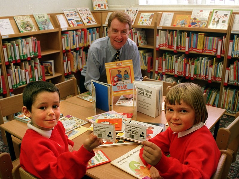 September 1999 and pupils Joe Cooper and Caitlin Beever hold their smart cards in the new Ash Tree Primary school library which was opened by MP. Colin Burgon.