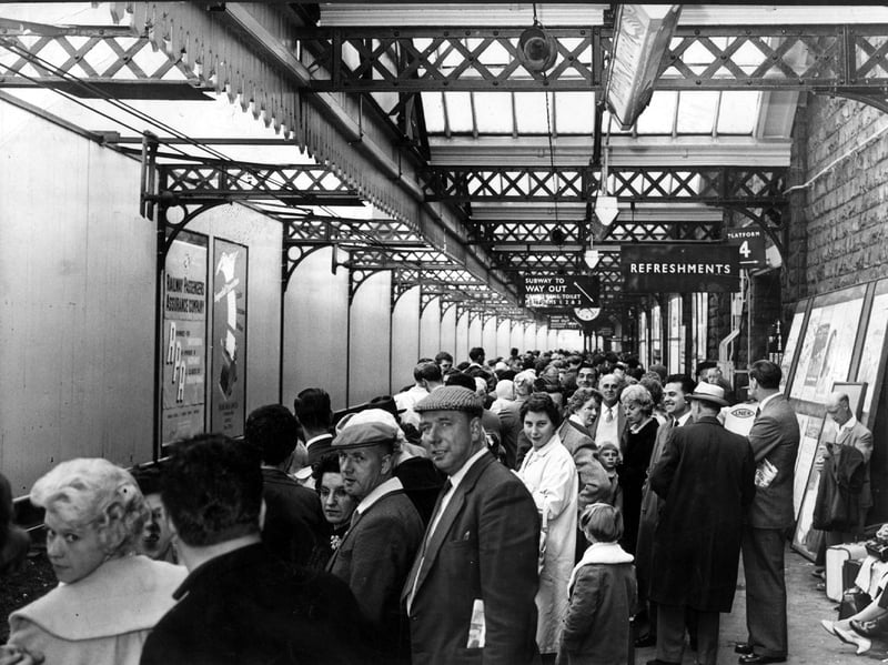 Holidaymakers wait for their train at Sheffield Victoria Station in 1962