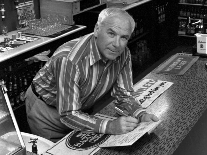 Lawrie Reilly, legendary Hibs football player (one of the Famous Five) behind the bar of his Leith pub the Bowlers' Rest in August 1985.