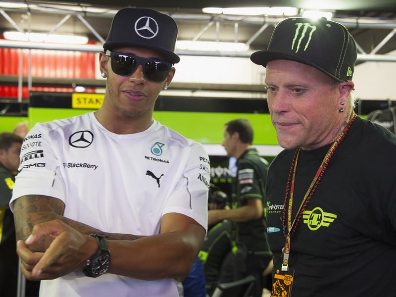 Lewis Hamilton (L) of Great Britain (Mercedes Formula 1 driver) speaks with Keith Flint of Great Britain (singer of The Prodigy) in box before the Moto GP race during the MotoGp of Catalunya - Race at Circuit de Catalunya on June 15, 2014 in Montmelo, Spain. 
