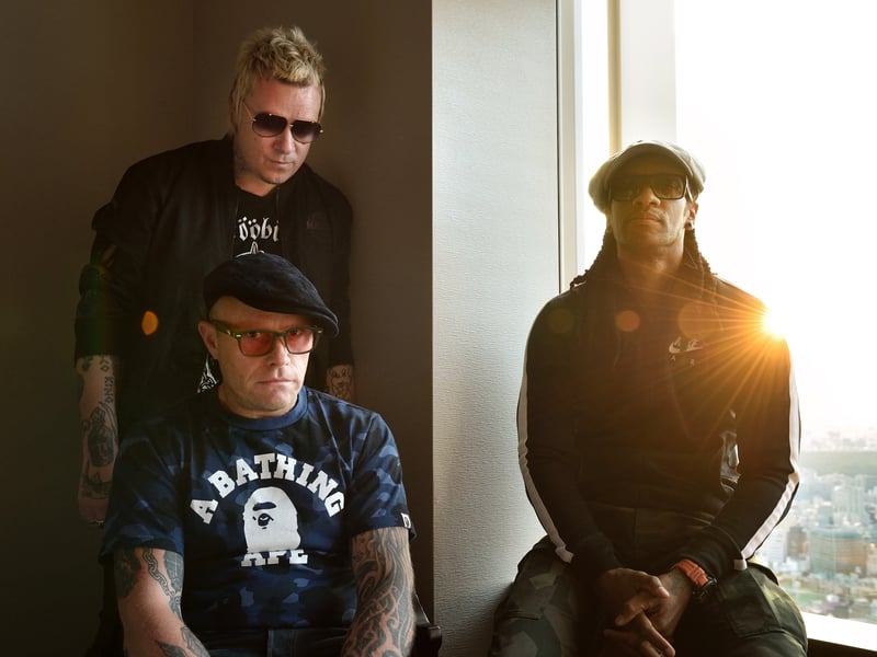 This photo taken on August 13, 2015 shows members of the British band The Prodigy, Liam Howlett (top L), Keith Flint (bottom L), and Maxim (R) posing prior to an interview in Tokyo. Techno-punk rockers The Prodigy, who took the world by storm with their angry lyrics and controversial videos in the 1990s, want to be viewed as a British "national treasure."
